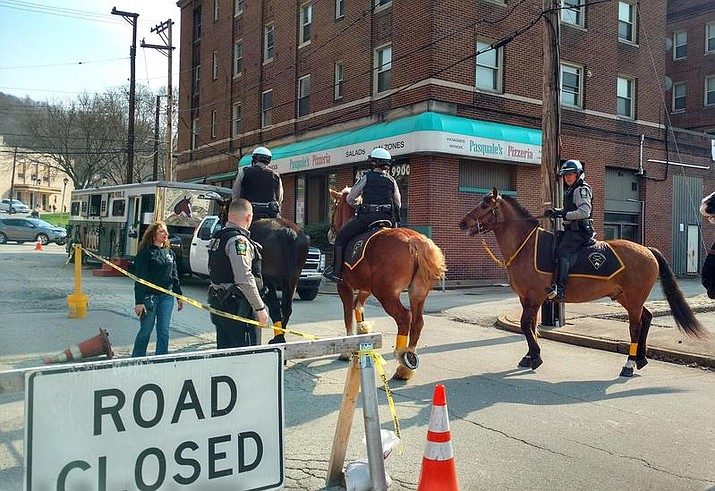 Mounted police units trot down Station Street in Wilmerding in a photo posted Tuesday, April 24, 2018, by the Allegheny County Police Department. (Allegheny County Police Department Facebook)
