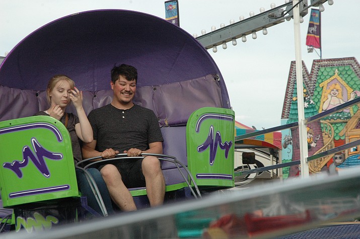 Loryn Winski and Kevin Vega ride the Tilt-a-Whirl at the Brown’s Amusements Carnival, held Thursday through Sunday, April 26-29 at Prescott Rodeo Grounds, 840 Rodeo Drive. Tokens are $1 each with a $25 per person special for a wristband granting unlimited rides. Wristbands are usually $30 per person. (Jason Wheeler/Courier)