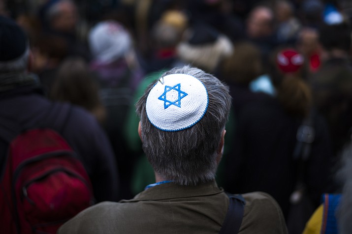 A man wears a Jewish skullcap, as he attends a demonstration against an anti-Semitic attack in Berlin, Wednesday, April 25, 2018. Germans of various faiths donned Jewish skullcaps and took to the streets Wednesday in several cities to protest an anti-Semitic attack in Berlin and express fears about growing hatred of Jews in the country. (AP Photo/Markus Schreiber)

