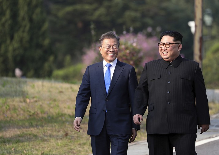 North Korean leader Kim Jong Un, right, and South Korean President Moon Jae-in walk together at the border village of Panmunjom in the Demilitarized Zone, South Korea, Friday, April 27, 2018. (Korea Summit Press Pool via AP)

