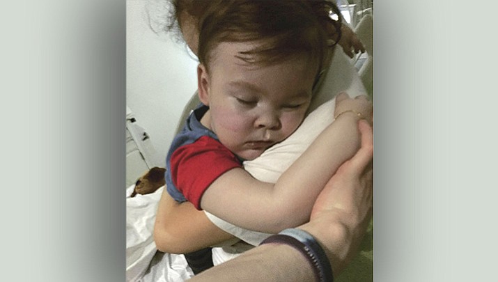 In this April 23, 2018 handout photo provided by Alfies Army Official, brain-damaged toddler Alfie Evans cuddles his mother Kate James at Alder Hey Hospital, Liverpool, England. Kate James and Tom Evans, the parents, said on Facebook that 23-month-old Alfie Evans, who had an incurable degenerative brain condition and was at the center of a legal battle over his treatment, died early morning Saturday April 28, 2018. (Alfies Army Official via AP)

