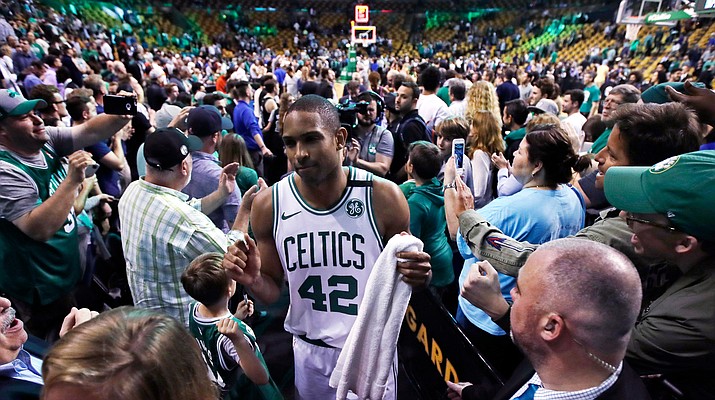Boston Celtics forward Al Horford (42) wades through a crowd of supports after the Celtics defeated the Milwaukee Bucks in Game 7 of an NBA basketball first-round playoff series in Boston, Saturday, April 28, 2018. Horford scored 26 points in the Celtics’ 112-96 win that eliminated the Bucks from the playoffs. (AP Photo/Charles Krupa)
