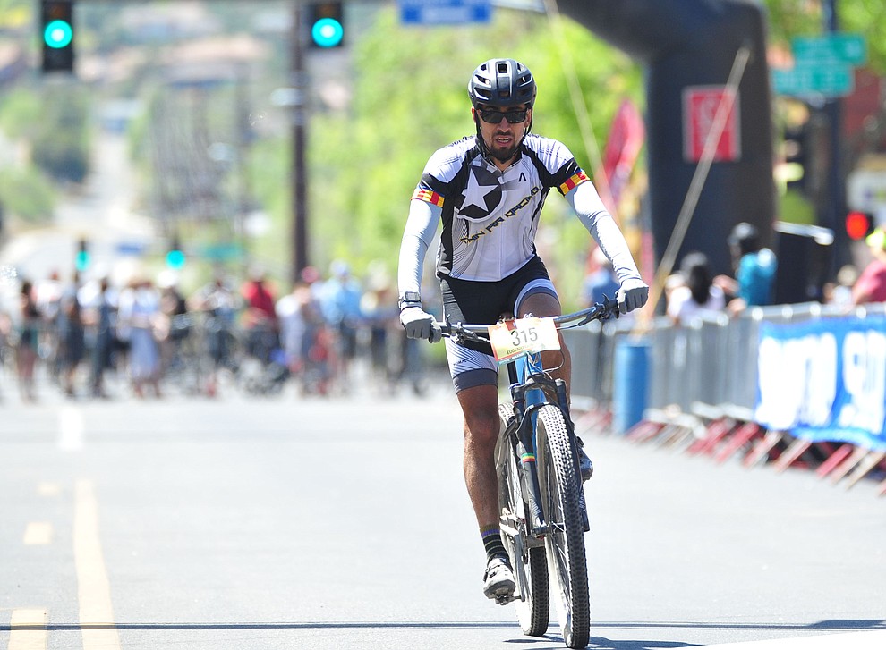 Eugenio Gonzalez crosses the finish line during the Whiskey Off Road 30 and 50 mile amateur races in Prescott Saturday, April 28, 2018. (Les Stukenberg/Courier)