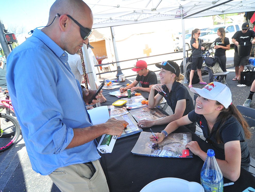 The Specialized Pro Team, Howard Grotts, Annika Langvad and Kate Courtney sign autographs during the Whiskey Off Road 30 and 50 mile amateur races in Prescott Saturday, April 28, 2018. (Les Stukenberg/Courier)