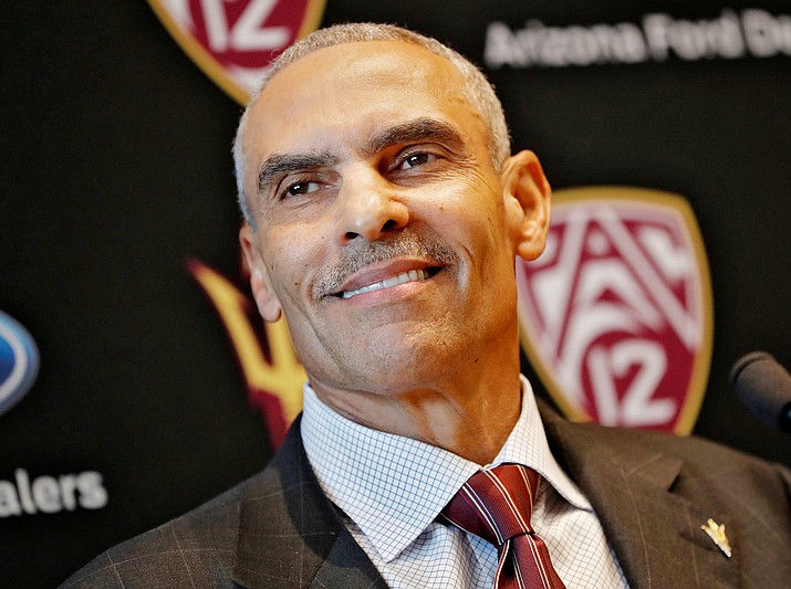 FILE - In this Dec. 4, 2017, file photo, new Arizona State University NCAA college football head coach Herman Edwards smiles during a news conference in Tempe, Ariz. The Pac-12 has five new coaches this season, so there was extra importance on spring football this year at UCLA, the two Arizona schools and the two Oregon schools. (AP Photo/Matt York, File)