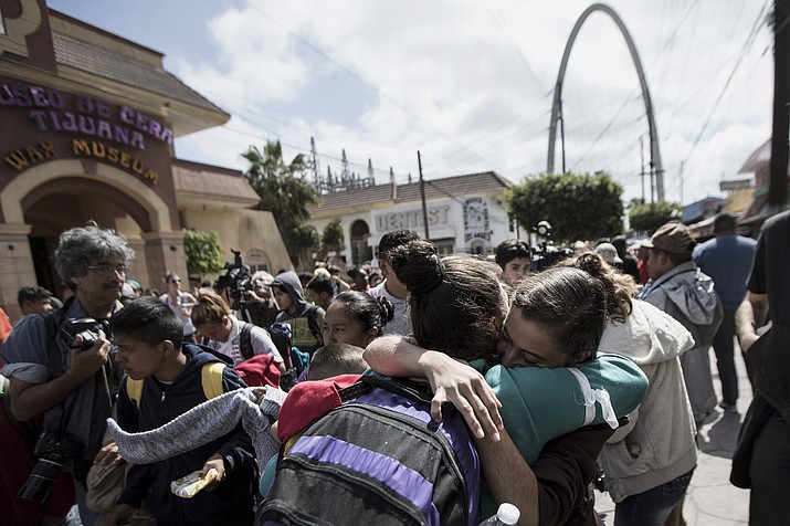 Central Americans who travel with a caravan of migrants embrace in Tijuana, Mexico, before crossing the border and request asylum in the United States, Sunday, April 29, 2018. A group of Central Americans who journeyed in a caravan to the U.S. border resolved to turn themselves in and ask for asylum Sunday in a direct challenge to the Trump administration - only to have U.S. immigration officials announce that the San Diego crossing was already at capacity. (AP Photo/Hans-Maximo Musielik)

