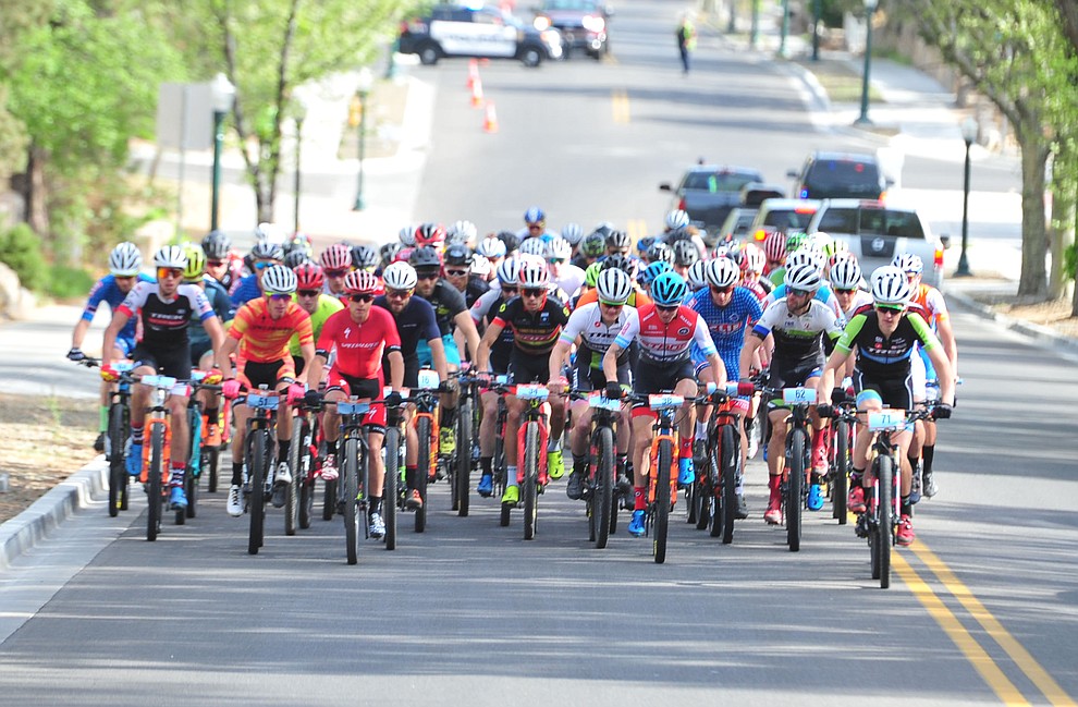 Men head up to the hills from downtown during the Whiskey Off Road 50-mile professional race in Prescott Sunday, April 29, 2018. (Les Stukenberg/Courier)