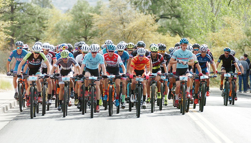 Men ride up Copper Basin Road as they head up to the trails from downtown during the Whiskey Off Road 50-mile professional race in Prescott Sunday, April 29, 2018. (Les Stukenberg/Courier)