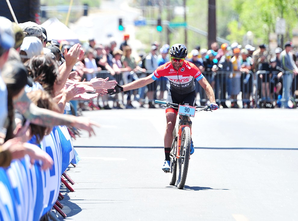 Travis Woodruff gets high fives from the fans during the Whiskey Off Road 50 mile professional race in Prescott Sunday, April 29, 2018. (Les Stukenberg/Courier)