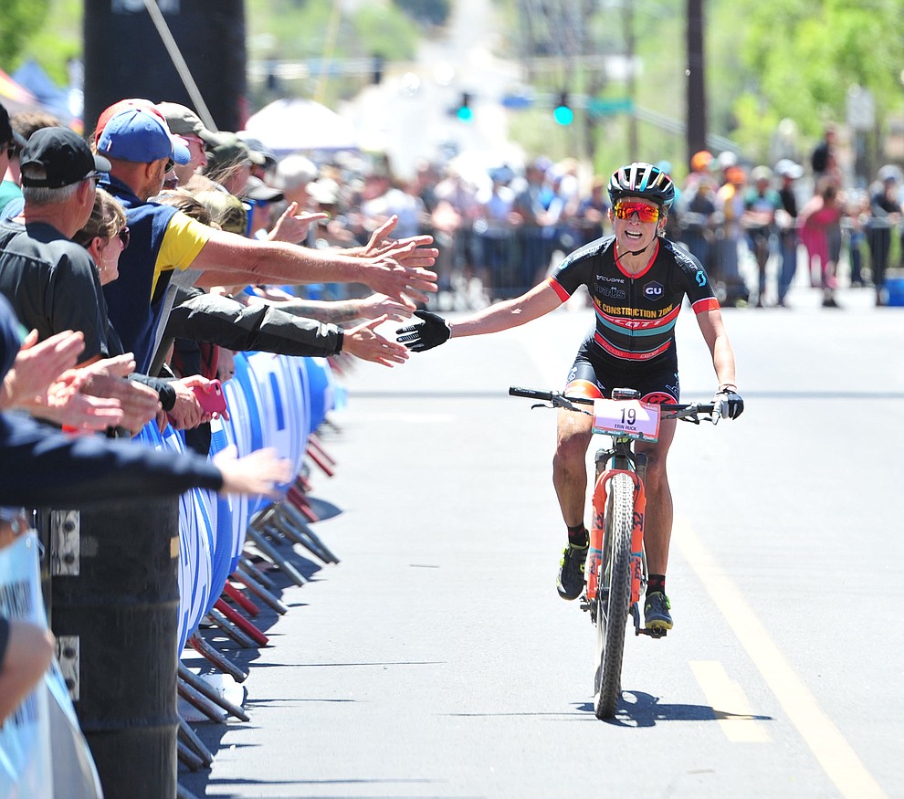 Erin Huck gets high fives from the fans during the Whiskey Off Road 50 mile professional race in Prescott Sunday, April 29, 2018. (Les Stukenberg/Courier)