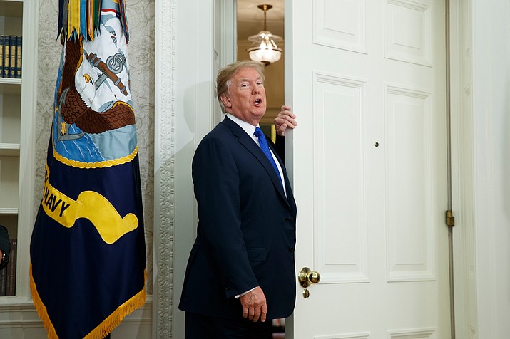 In this Nov. 2, 2017 file photo, President Donald Trump talks with reporters as he leaves an event to announce that Broadcom is moving its global headquarters to the United States, in the Oval Office of the White House in Washington. The presidential news conference, a time-honored tradition going back generations, appears to be no longer. Instead, the president engages the press in more informal settings that aides say offer reporters far more access, more often, than past administrations. (AP Photo/Evan Vucci, File)


