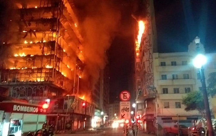 In this photo released by Sao Paulo Fire Department, a building on fire is seen in Sao Paulo, Brazil, Tuesday, May 1, 2018. A burning building in downtown Sao Paulo has collapsed as firefighters worked to put out a fire that began in the middle of the night. (Sao Paulo Fire Department via AP)

