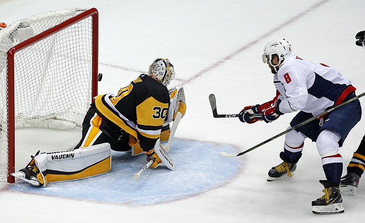 Washington Capitals’ Alex Ovechkin (8) puts the go-ahead goal behind Pittsburgh Penguins goaltender Matt Murray (30) during the third period in Game 3 of an NHL second-round hockey playoff series in Pittsburgh, Tuesday, May 1, 2018. (AP Photo/Gene J. Puskar)