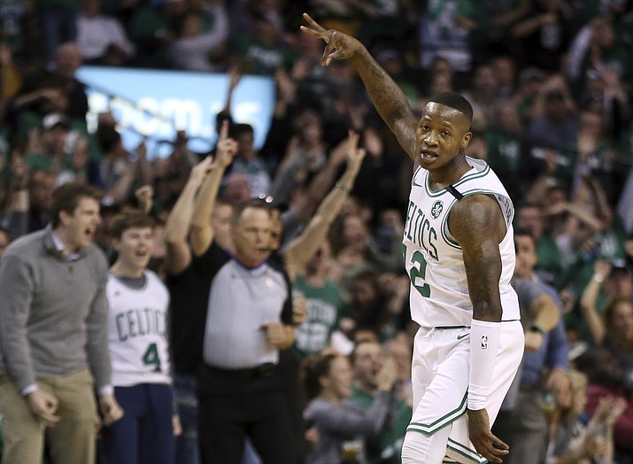 Boston Celtics guard Terry Rozier (12) celebrates his three-point shot against the Philadelphia 76ers in the first quarter of Game 1 of an NBA basketball second-round playoff series, Monday, April 30, 2018, in Boston. (AP Photo/Elise Amendola)