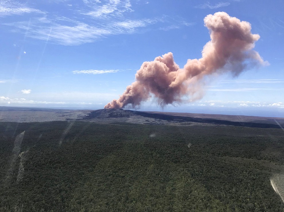 In this photo released by U.S. Geological Survey, ash plume rises above the Puu Oo vent, on Hawaii's Kilaueaa Volcano Thursday, May 3, 2018 in Hawaii Volcanoes National Park. Nearly 1,500 residents were ordered to evacuate from their volcano-side homes after Hawaii's Kilauea Volcano erupted, sending molten lava to chew its way through forest land and bubble up on paved streets. (U.S. Geological Survey)