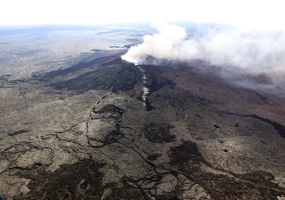 In this photo released by U.S. Geological Survey, ash plume rises above the Puu Oo crater, on Hawaii's Kilaueaa Volcano Thursday, May 3, 2018 in Hawaii Volcanoes National Park. Nearly 1,500 residents were ordered to evacuate from their volcano-side homes after Hawaii's Kilauea Volcano erupted, sending molten lava to chew its way through forest land and bubble up on paved streets. (U.S. Geological Survey)