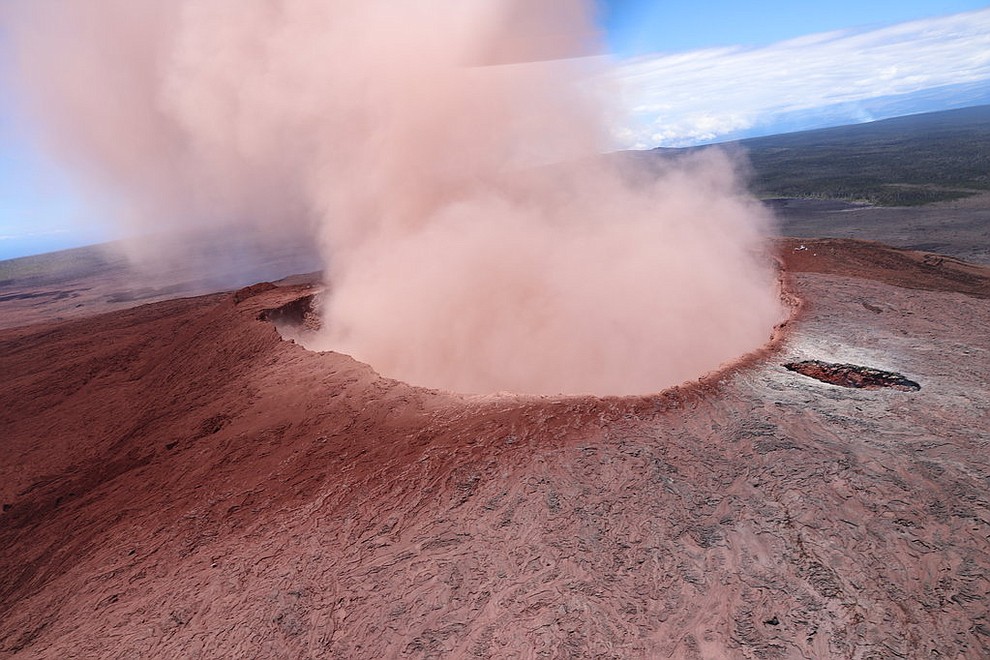 In this photo released by U.S. Geological Survey, a plume of ash rises from the Puu Oo crater on Hawaii's Kilaueaa Volcano, Thursday, May 3, 2018 in Hawaii Volcanoes National Park. Hawaii's Kilauea volcano erupted Thursday, sending lava shooting into the air in a residential neighborhood and prompting mandatory evacuation orders for nearby homes. Hawaii County said steam and lava poured out of a crack in Leilani Estates, which is near the town of Pahoa on the Big Island. (U.S. Geolgogical Survey)