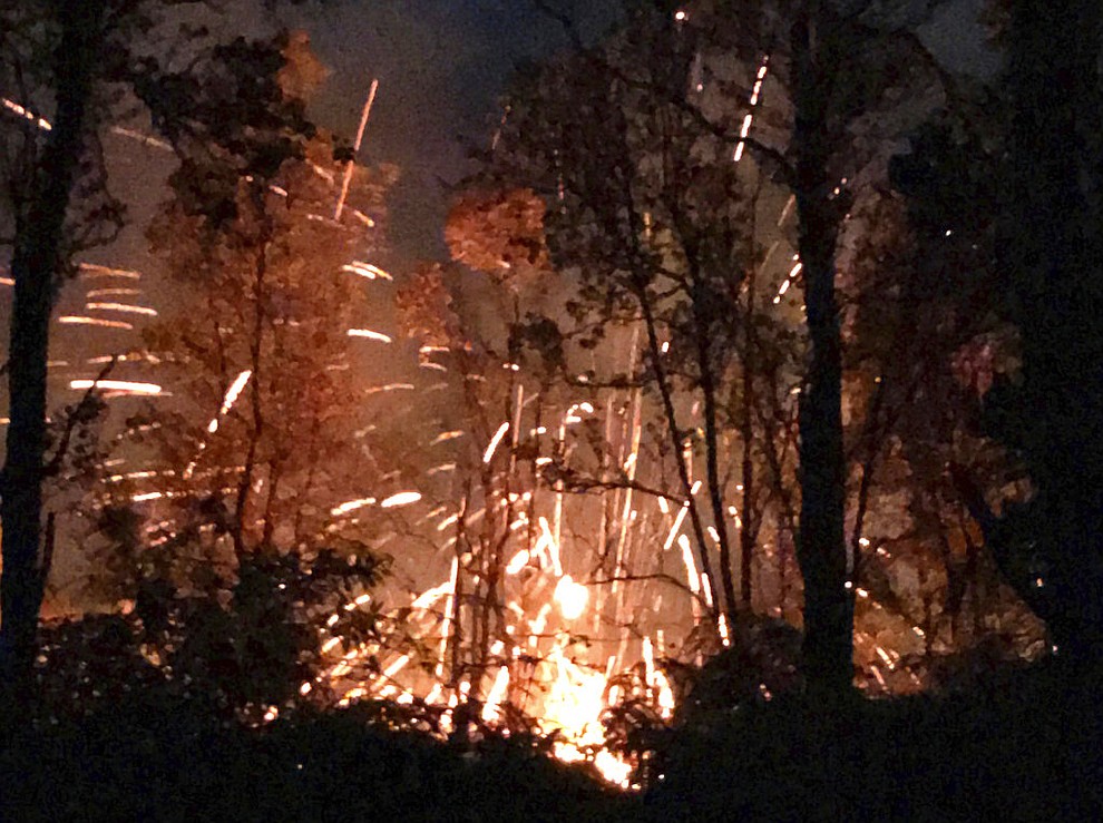 This photo provided by Shane Turpin shows results of the eruption from Kilauea Volcano on Hawaii's Big Island Friday, May 4, 2018. The eruption sent molten lava through forests and bubbling up from paved streets and forced the evacuation of about 1,500 people who were still out of their homes Friday after Thursday's eruption. (Shane Turpin/seeLava.com via AP)