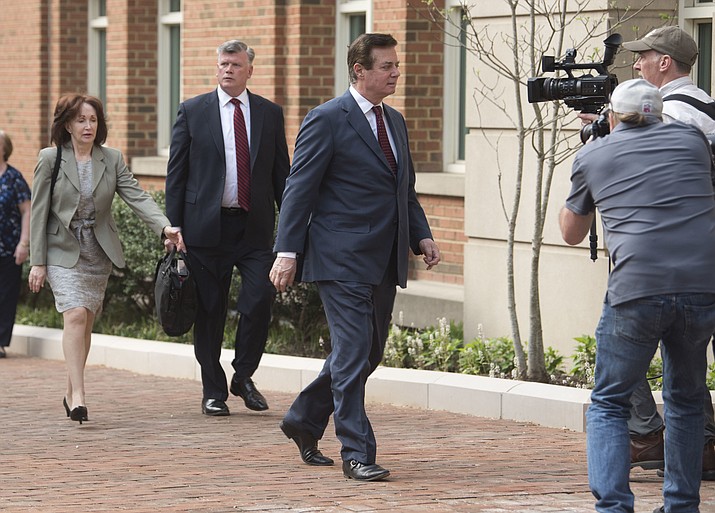 Paul Manafort walks into the Alexandria Federal Courthouse on Friday, May 4, 2018, in Alexandria, Va., with his wife Kathleen Manafort, left, and Kevin Downing, attorney for Manafort. (AP Photo/Kevin Wolf)

