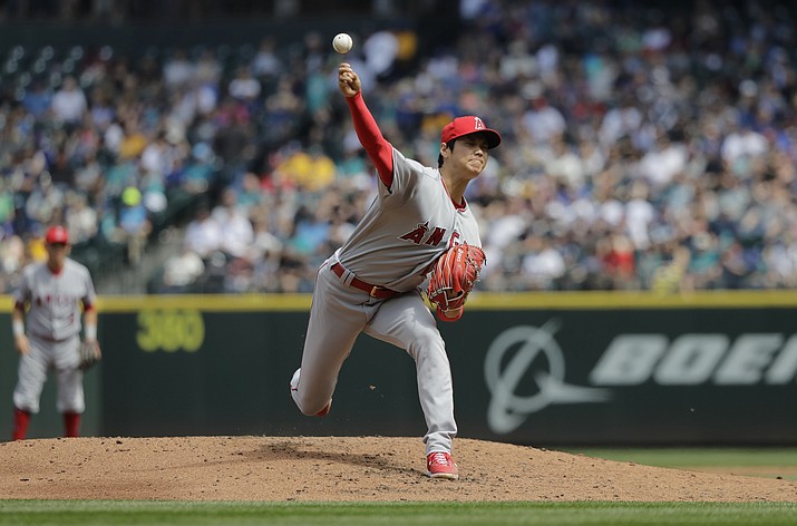 Los Angeles Angels starting pitcher Shohei Ohtani throws against the Seattle Mariners in the third inning of a baseball game, Sunday, May 6, 2018, in Seattle. (AP Photo/Ted S. Warren)