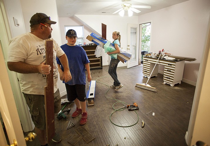 In this April 30, 2018, photo, people work to renovate the Short Creek Dream Center, formally the home of polygamous sect leader Warren Jeffs in Hildale, Utah. The sprawling house surrounded by towering brick walls has been converted into a sober living center by Evangelical missionaries in small community on the Utah-Arizona border. (Chris Caldwell/The Spectrum via AP)