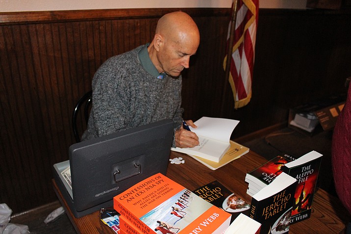 Author Barry Webb signs copies of his book after a recent Kingman Republican Women meeting. KRW meets at 12:30 p.m. Tuesday, May 8, at the Dam Bar and Steak House, 1960 E. Andy Devine Ave.