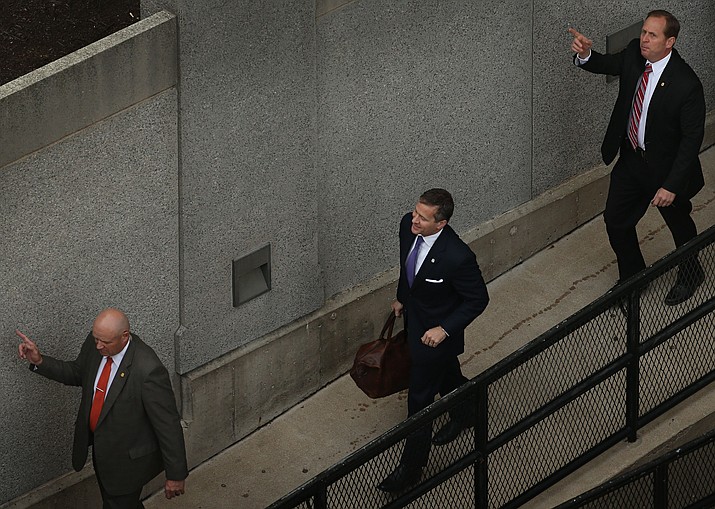 Flanked by security guards, Missouri Gov. Eric Greitens, center, arrives at court for jury selection in his felony invasion of privacy trial, Thursday, May 10, 2018, in St. Louis. Greitens is accused of taking an unauthorized and compromising photo of a woman with whom he had an affair. (David Carson/St. Louis Post-Dispatch via AP)

