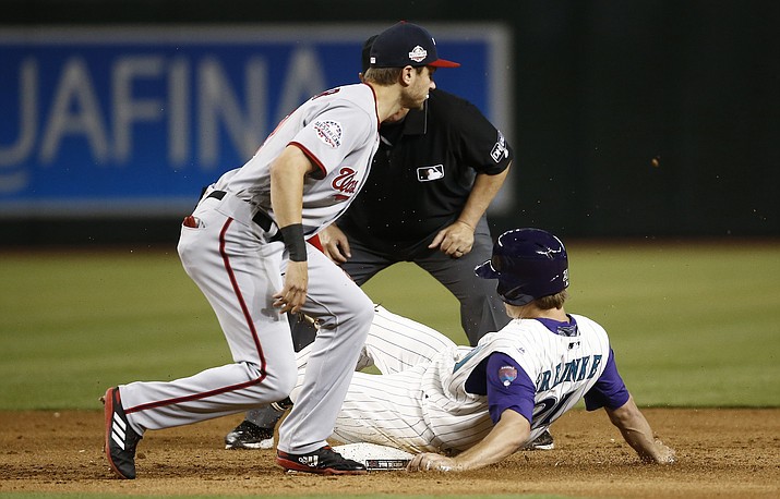 Arizona Diamondbacks' Zack Greinke, right, steals second base as Washington Nationals shortstop Trea Turner, left, applies a late tag during the fifth inning of a baseball game Thursday, May 10, 2018, in Phoenix. (Ross D. Franklin/AP)