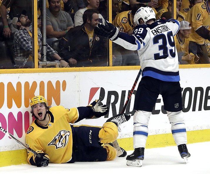 Nashville Predators left wing Kevin Fiala, left, of Switzerland, looks for a penalty call after being checked by Winnipeg Jets defenseman Toby Enstrom (39), of Sweden, during the second period in Game 7 on Thursday, May 10, 2018, in Nashville, Tenn. (Mark Humphrey/AP)