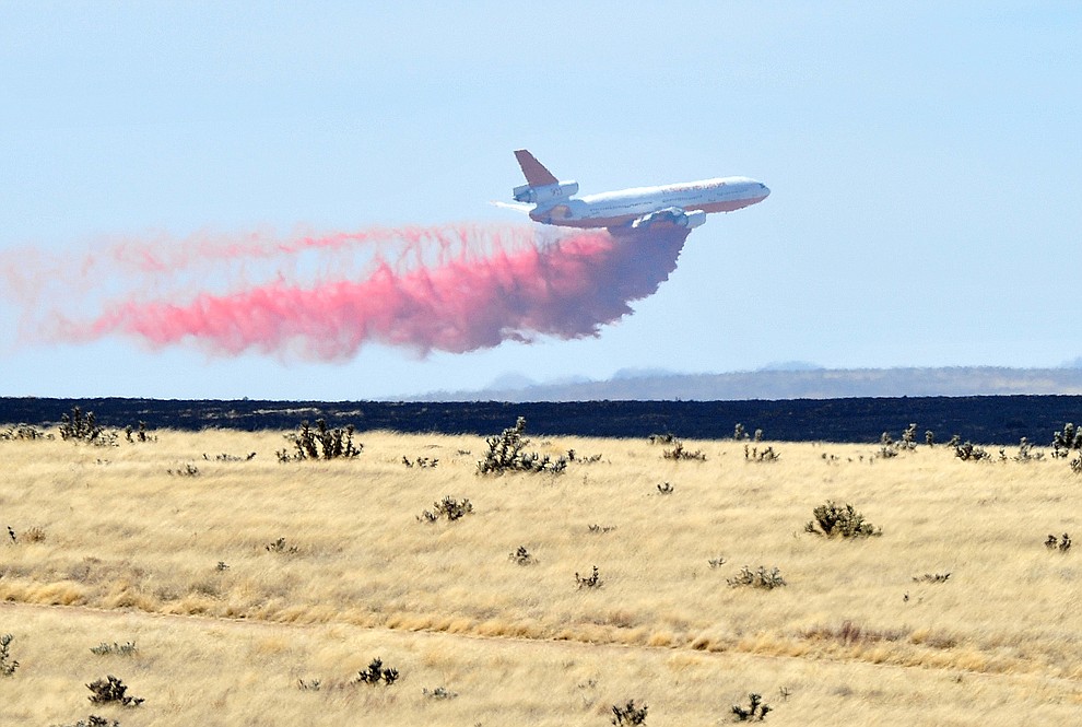 A DC-10 drops a load of retardant along the western edge of the Viewpoint Fire that started along Highway 89A in Prescott Valley Friday morning, May 11, 2018. The fire, driven by a sustained wind, headed north into the Poquito Valley area. (Les Stukenberg/Courier)