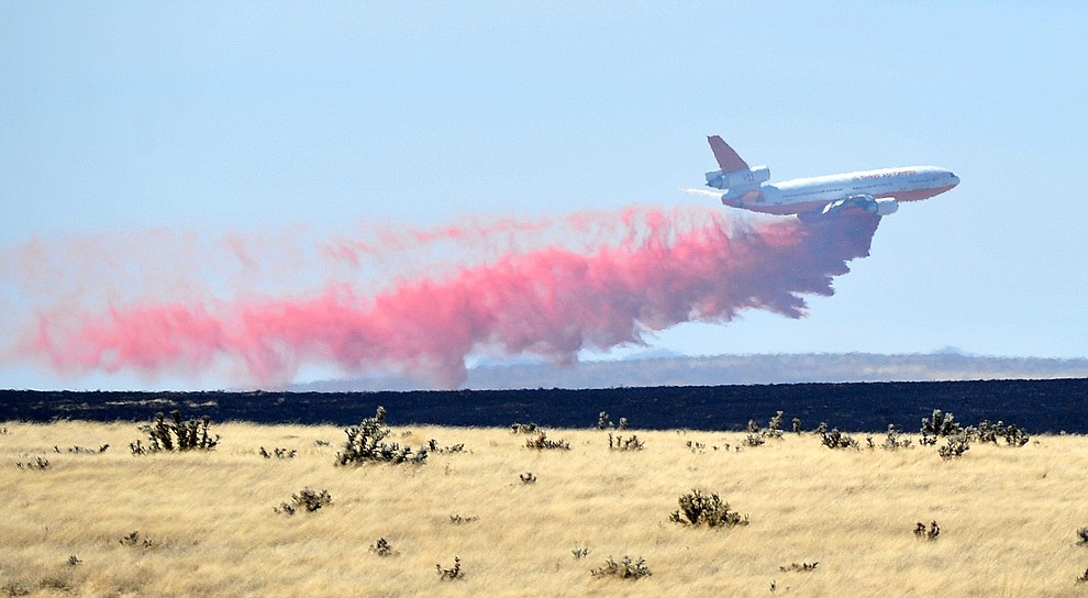 A DC-10 drops a load of retardant along the western edge of the Viewpoint Fire that started along Highway 89A in Prescott Valley Friday morning, May 11, 2018. The fire, driven by a sustained wind, headed north into the Poquito Valley area. (Les Stukenberg/Courier)