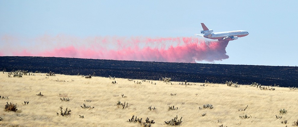 A DC-10 drops a load of retardant along the western edge of the Viewpoint Fire that started along Highway 89A in Prescott Valley Friday morning, May 11, 2018. The fire, driven by a sustained wind, headed north into the Poquito Valley area. (Les Stukenberg/Courier)