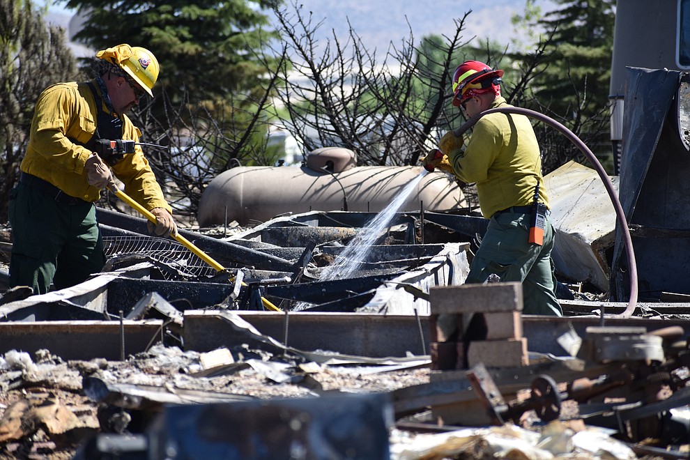 On the morning of May 12, 2018, fire crews put out hot spots on a home destroyed a day earlier by the Viewpoint Fire in the 7000 block of Whisper Ranch Road in the Poquito Valley community of Prescott Valley, Arizona. (Richard Haddad/WNI)