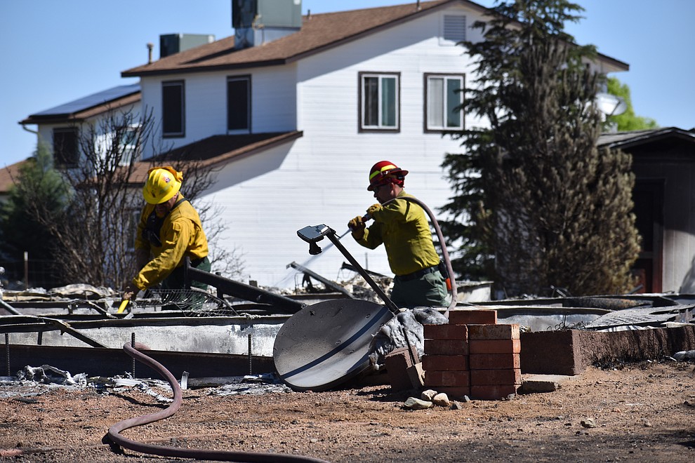 On the morning of May 12, 2018, fire crews put out hot spots on a home destroyed a day earlier by the Viewpoint Fire in the 7000 block of Whisper Ranch Road in the Poquito Valley community of Prescott Valley, Arizona. (Richard Haddad/WNI)
