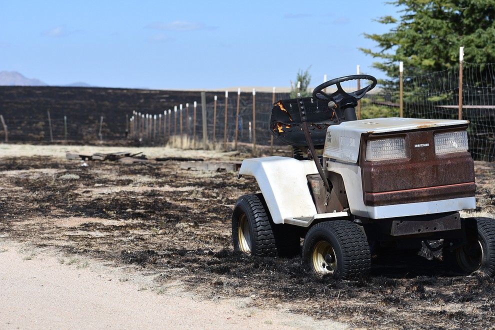 A riding lawn mower with its wheels melted sits in the yard of a home that was destroyed by the May 11, 2018, Viewpoint Fire in the Poquito Valley area of Prescott Valley, Arizona. (Richard Haddad/WNI)
