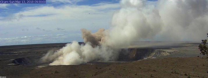 This Sunday, May 13, 2018, image, released by the U.S. Geological Survey, shows the Kīlauea Caldera at 9:30 a.m. HST, taken with a research camera mounted in the observation tower at the Hawaiian Volcano Observatory in the Big Island of Hawaii. The camera is looking south-southeast, toward the active vent in Halemaʻumaʻu, 1.9 km (1.2 miles) from the webcam. For scale, Halemaʻumaʻu is approximately 1 km (0.6 mi) across and about 85 m (~280 ft) deep. 
A new fissure emitting steam and lava spatter spurred Hawaii officials to call for more evacuations on Sunday as residents braced for an expected eruption from the Kilauea volcano. Geologists warn that Kilauea's summit could have an explosive steam eruption that would hurl rocks and ash miles into the sky. (U.S. Geological Survey via AP)