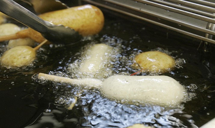 A Milky-Way candy bar is deep-fried in oil free of trans fats at a food booth at the Indiana State Fair in Indianapolis on Aug. 8, 2007. Indiana was the first state to require the switch in cooking oil at its state fair. On Monday, May 14, 2018, the head of the World Health Organization called on all nations to eliminate artificial trans fats from foods in the next five years. (AP Photo/Darron Cummings, file)
