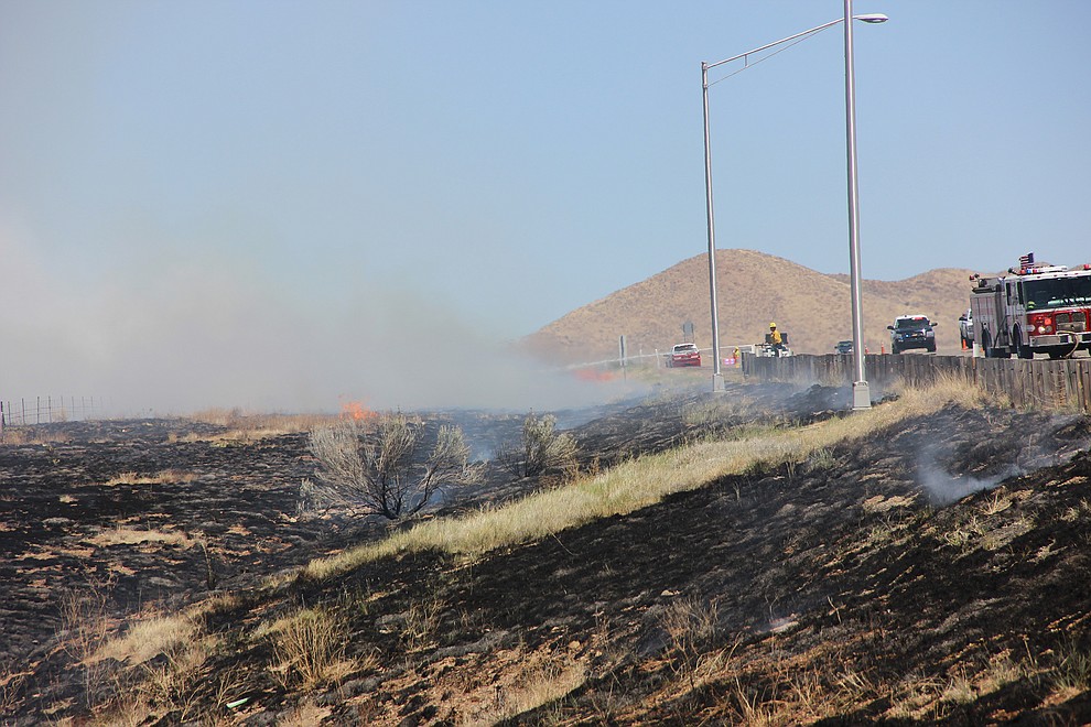 Area firefighter crews work to extinguish a wind-driven wildland fire along Fain Road in Prescott Valley Monday, May 14, 2018. (Max Efrein/Courier)