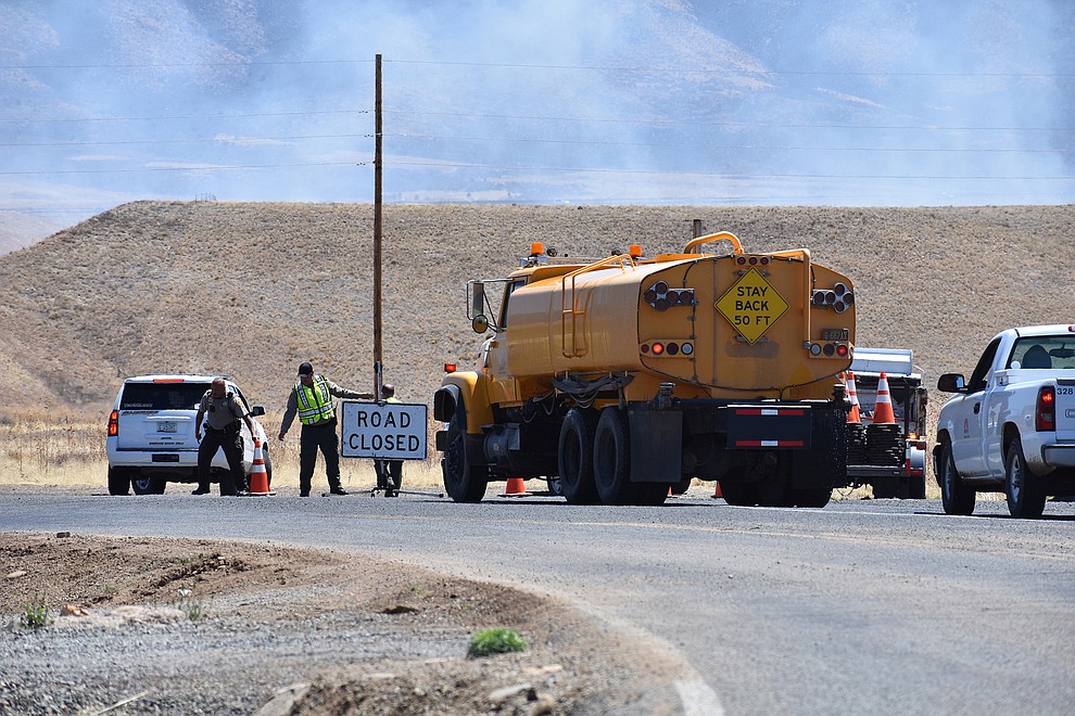 Officials close Lakeshore Drive in Prescott Valley  as firefighters battle a wildland fire near the intersection of Fain Road and Lakeshore Drive around 10:40 a.m. on Monday, May 14, 2018. (Richard Haddad/WNI)