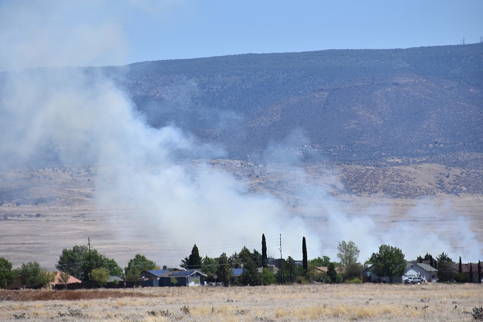 Fire crews battle a wildland fire along Fain Road in Prescott Valley Monday, May 14, 2018. The fire, which began near the intersection of Fain Road and Lakeshore Drive around 10 a.m. spread along open grasslands, initially alarming residents in the nearby Superstition Hills neighborhood. (Richard Haddad/WNI)