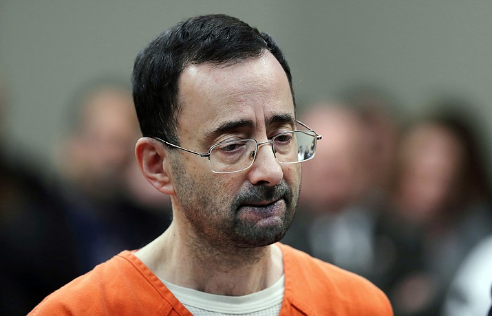 In this Nov. 22, 2017 file photo, Dr. Larry Nassar, 54, appears in court for a plea hearing in Lansing, Mich. Michigan State University announced Wednesday, May 16, 2018, that it has reached a $500 million settlement with hundreds of women and girls who say they were sexually assaulted by sports Nassar in the worst sex-abuse case in sports history. (AP Photo/Paul Sancya, File)

