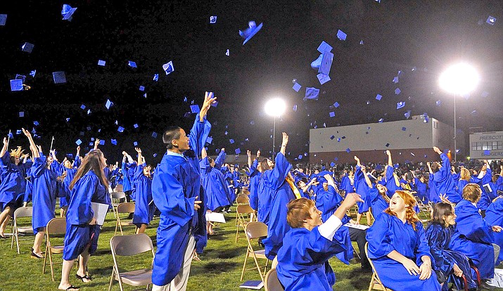 Grads toss their caps at the 2010 Prescott High School graduation at Bill Shepherd Field. (Courier, file)