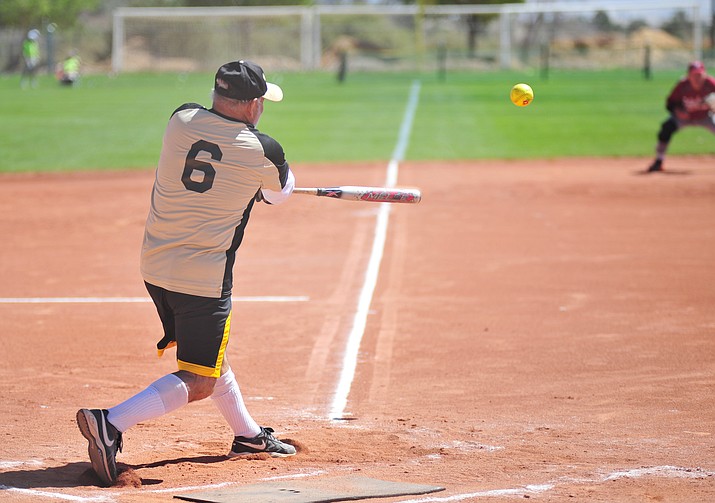 Old Pueblo AAA’s player Steve Garceau connects during the opening games of the Tobin-Glick Memorial Senior Softball Tournament on Thursday, May 17, 2018, at Pioneer Park in Prescott. (Les Stukenberg/Courier)
