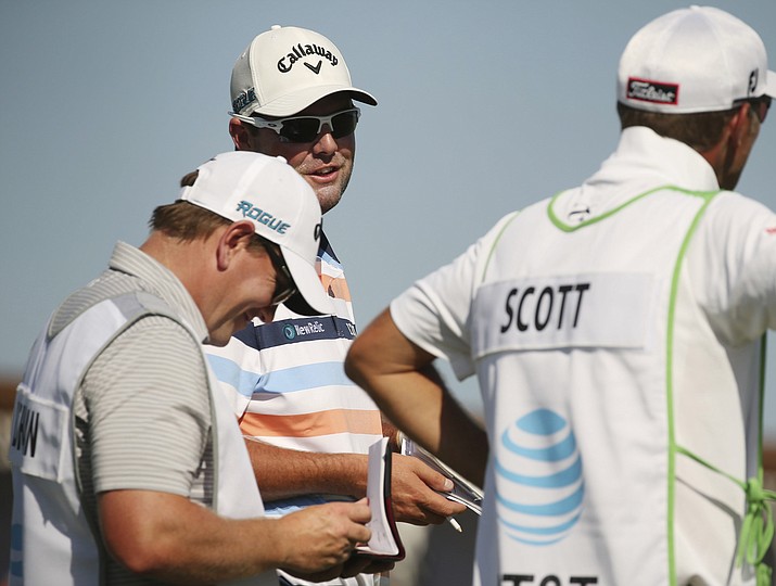 Marc Leishman, of Australia, speaks to caddies after parring the 15th hole dduring the first round of the AT&T Byron Nelson golf tournament Thursday, May 17, 2018, at Trinity Forest in Dallas. (Andy Jacobsohn/AP)