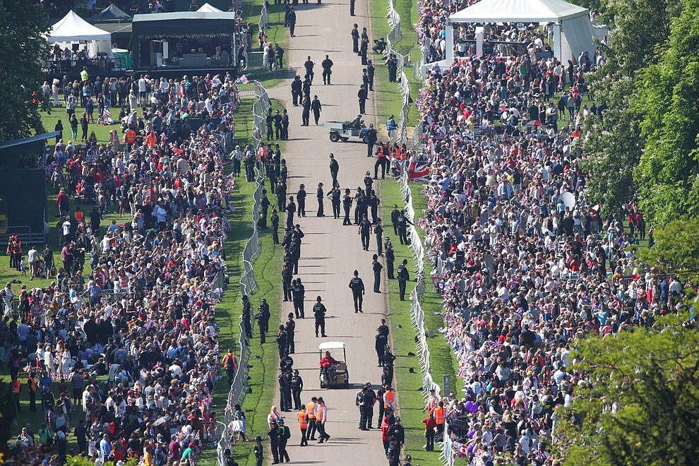 Spectators gather along the Long Walk ahead of the wedding of Prince Harry and Meghan Markle at Windsor castle in Windsor near London, England, Saturday May 19, 2018. (Yui Mok/PA via AP)