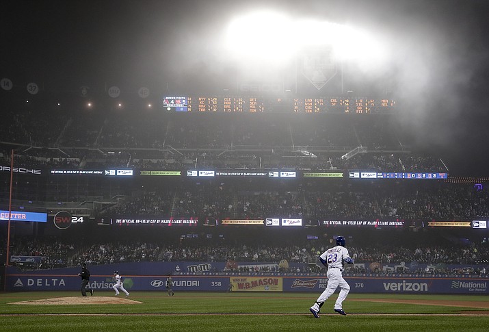 New York Mets’ Adrian Gonzalez (23) makes his way up the first base line on a fly-out to left field as a blanket of fog hangs over CitiField during the sixth inning of a baseball game against the Arizona Diamondbacks, Saturday, May 19, 2018, in New York. (Julie Jacobson/AP)