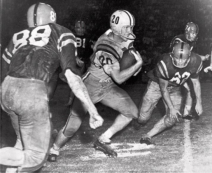 This this Oct. 31, 1959, file photo, Billy Cannon, Louisiana State University's All-America halfback, slips by tacklers at the start of an 89-yard punt return for a touchdown to help LSU beat third-ranked Mississippi, 7-3 in Baton Rouge, La. Cannon, the gifted running back who won the Heisman Trophy for LSU in 1959 with a memorable Halloween night punt return touchdown against Mississippi, died Sunday, May 20, 2018. He was 80. LSU said Cannon, the school’s only Heisman winner, died at his home in St. Francisville, La. The cause of death was not immediately known. (AP Photo/File)

