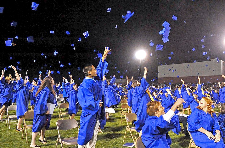 Grads toss their caps at the 2010 Prescott High School graduation at Bill Shepherd Field. (Courier, file)