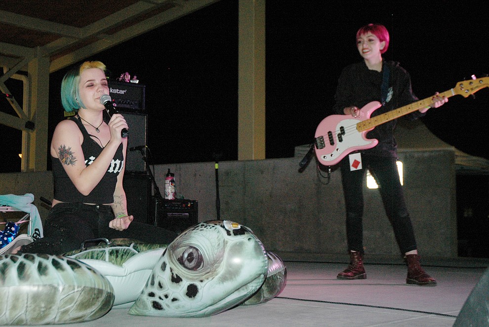 Doll Skin lead vocalist Sydney Dolezal sits atop an inflatable turtle while bassist Nicole Rich smiles at the shenanigans happening as the band headlines the first night of the Prescott Valley Music Festival Saturday, May 19, at the Theatre on the Green. (Jason Wheeler/Tribune)