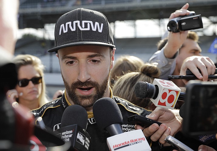In this May 19, 2018 file photo, James Hinchcliffe, of Canada, talks with the media after he did not qualify for the IndyCar Indianapolis 500 auto race at Indianapolis Motor Speedway in Indianapolis. James Hinchcliffe once likened Indianapolis Motor Speedway to a cruel mistress. He found out just how cruel when he was bumped from the race that means the most to him and to any IndyCar driver. But he will be at the track Sunday trying to help his teammates win the Indy 500. (Darron Cummings/AP, File)